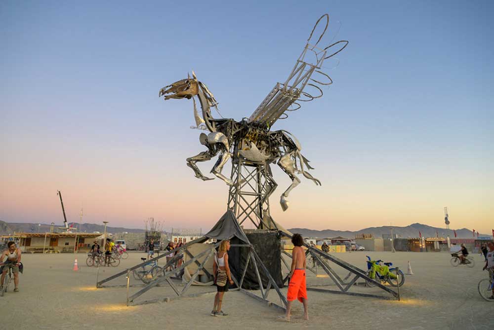 In order to see Nebula Rider run, fly and flame all at the same time – for a timed one-minute period – Burning Man attendees had to work together, simultaneously pressing eight buttons that were situated around the base | Adrian Landon In order to see Nebula Rider run, fly and flame all at the same time – for a timed one-minute period – Burning Man attendees had to work together, simultaneously pressing eight buttons that were situated around the base | Adrian Landon