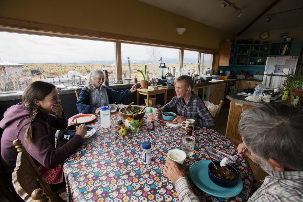 photos by Kelsey Brunner, the gazette Morgan Atkinson, left, Julie Sullivan, Hana Fancher and George Whitten share a laugh over their homemade chili at San Juan Ranch near Saguache. The team tries to share a meal together every day. Whitten and Sullivan emphasize the importance of teaching their apprentices how to prepare their own food. Equine Info Exchange