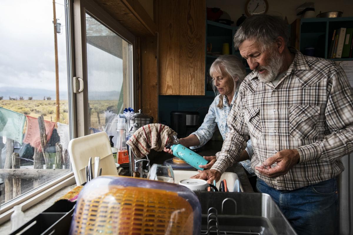 Julie Sullivan, left, and George Whitten clean the dishes after a shared lunch with their apprentices . Equine Info Exchange