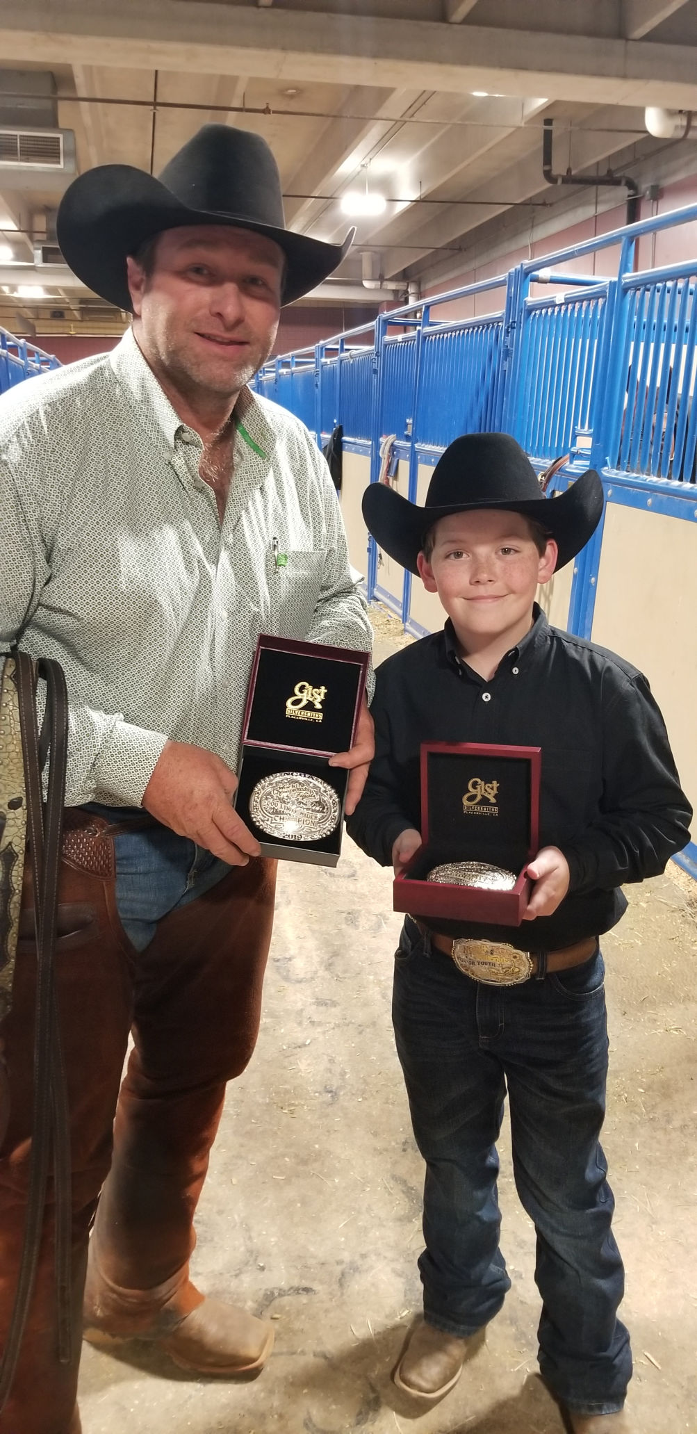 Casey Crouch and Aden Bernhagen show off their buckles during the National Cutting Horse Association World Finals. Casey Crouch and Aden Bernhagen show off their buckles during the National Cutting Horse Association World Finals.
