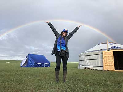 Heather Wallace celebrates a double rainbow in front of the ger she shared with the other female Officials in Mongolia, The Land of the Eternal Blue Sky. © Gobi Desert Cup Heather Wallace celebrates a double rainbow in front of the ger she shared with the other female Officials in Mongolia, The Land of the Eternal Blue Sky. © Gobi Desert Cup