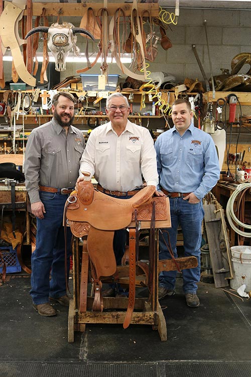 Richard Oliver, center, is 3rd generation of owner of Oliver Saddle Shop, a multi-generational, century old business in Amarillo, Texas. His sons Zeb, left, and Bryan, right, work alongside their father.